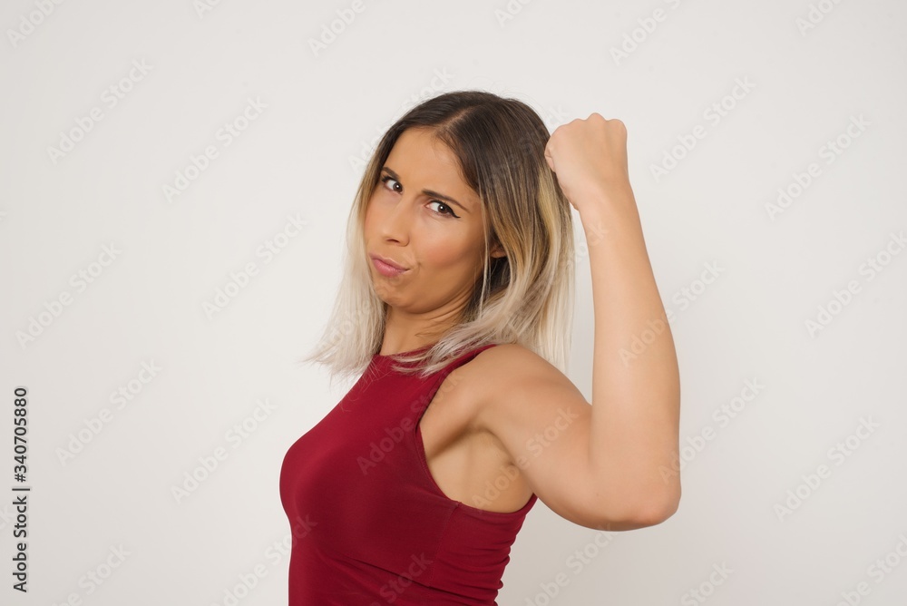 Overjoyed happy excited blonde female glad to receive good news, gestures actively from happiness, clenching fist and making winning gesture. Reaction concept. Overjoyed happy excited blonde female glad to receive good news, gestures actively from happiness, clenching fist and making winning gesture. Reaction concept.