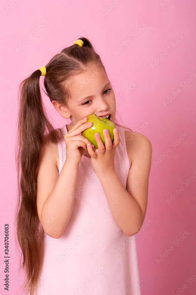 Studio close-up portrait of caucasian girl with funny hairstyle, biting big green apple, Studio close-up portrait of caucasian girl with funny hairstyle, biting big green apple,