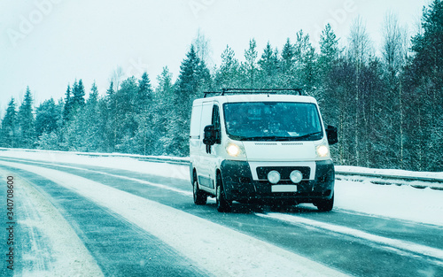 Mini van at Snowy Winter Road in Finland Lapland reflex