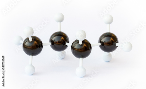 Plastic ball-and-stick model of a butane (chemical formula C4H8) molecule on a white background. Butane is commonly used as fuel. photo