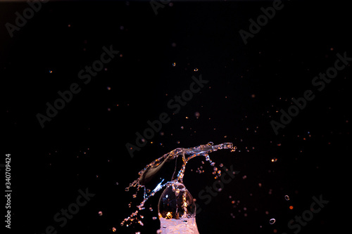 Hi speed macro photography of water with bright colors dripping and splashing