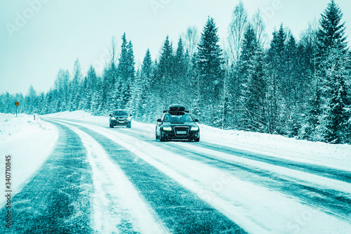 Car with roof rack in winter snowy road at Rovaniemi reflex photo