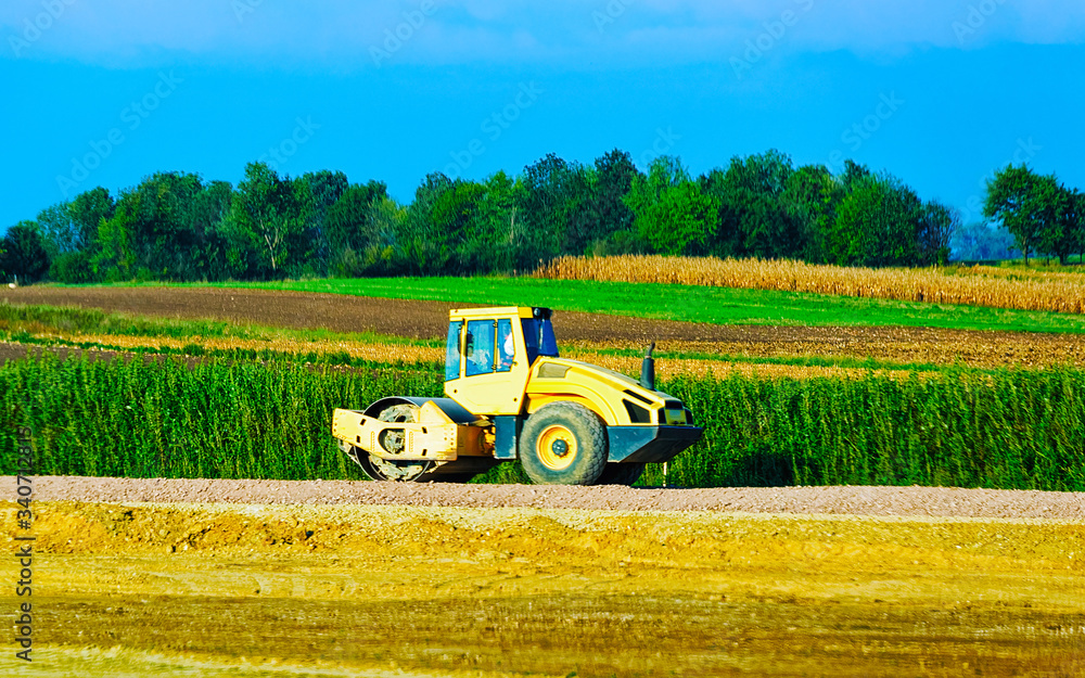 Fototapeta premium Road roller on road reflex