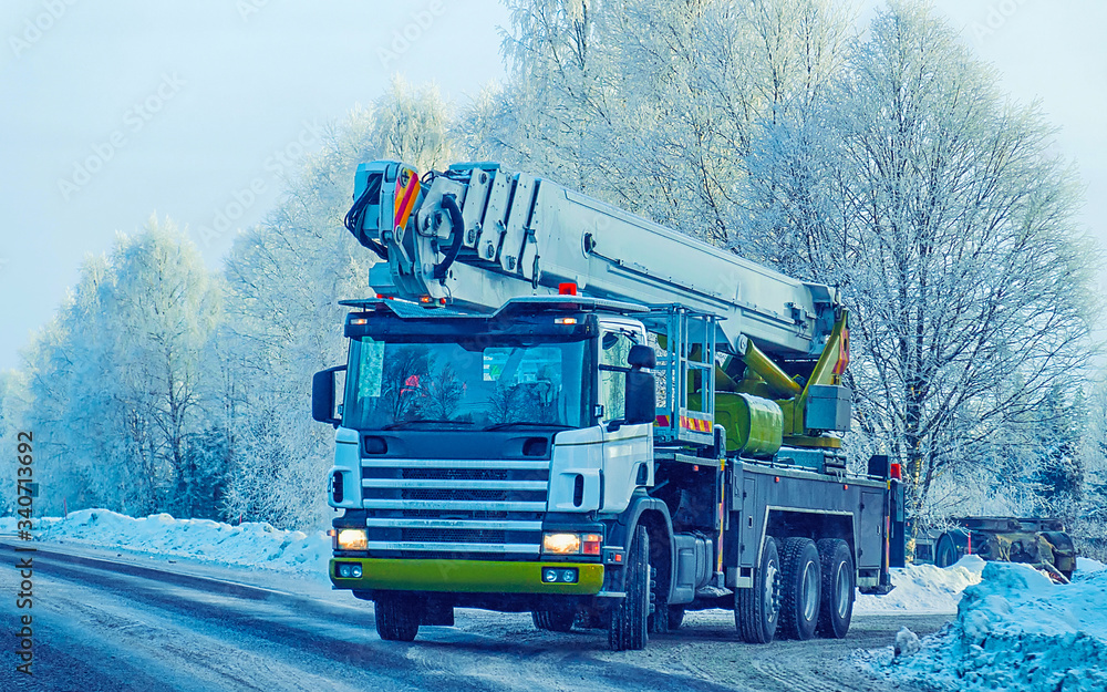 Lorry with lifting crane in road in winter Rovaniemi reflex Lorry with lifting crane in road in winter Rovaniemi reflex