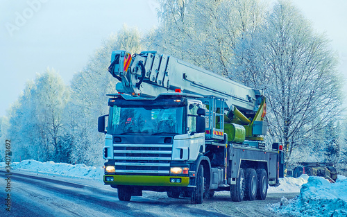 Lorry with lifting crane in road in winter Rovaniemi reflex photo