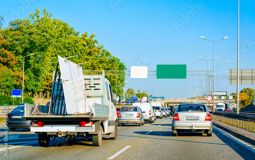 Fotografie Car carrying trailer in asphalt road of Slovenia reflex