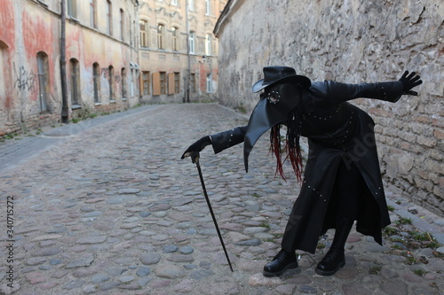 Costume plague doctor in the city streets