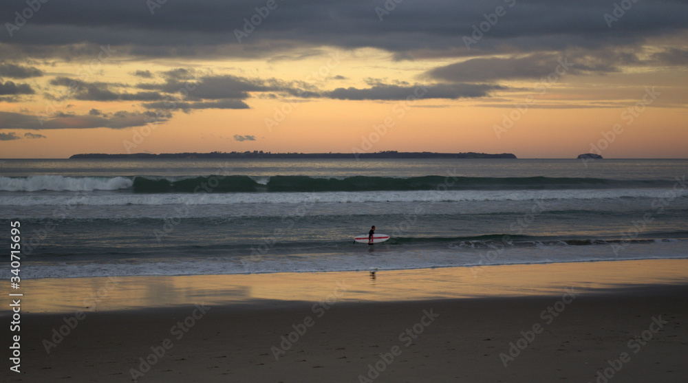 Ssurfer walking near the sea at the beach