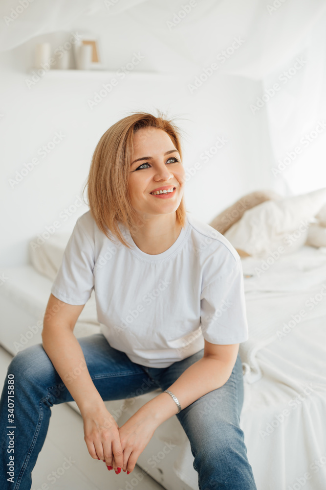 girl in a white t-shirt on the bed girl in a white t-shirt on the bed