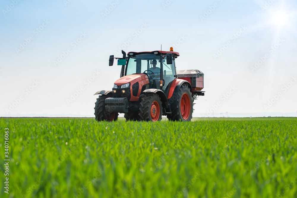 Tractor spreading artificial fertilizers Tractor spreading artificial fertilizers