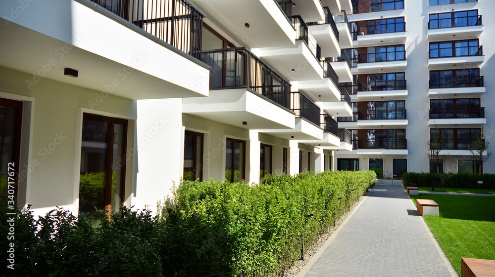 Fototapeta premium Modern apartment building on a sunny day with a blue sky. Facade of a modern apartment.