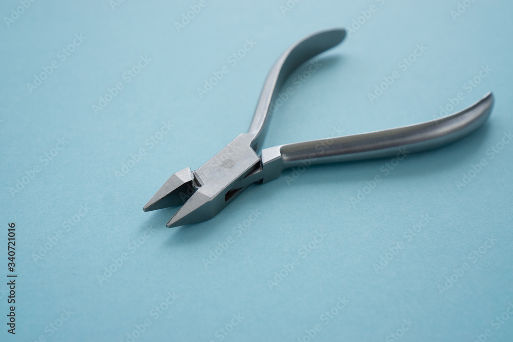 Gelendzhik, Russia -   April 12, 2020:  Adams orthodontic pliers on a blue background