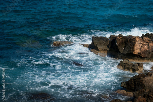 rocky coast and blue sea with waves