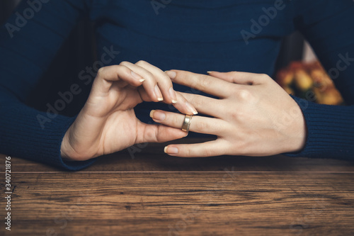 woman remove the wedding ring photo