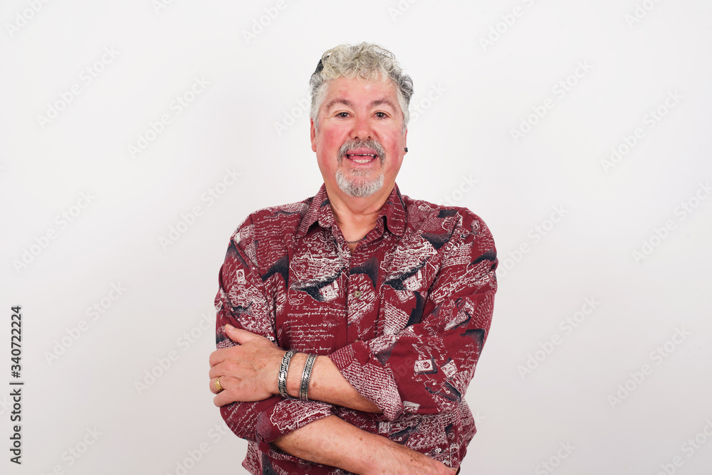 Lovely good-natured young caucasian man having charming smile and friendly expression holding himself wanting to show his love and sympathy. My heart is for you! Lovely good-natured young caucasian man having charming smile and friendly expression holding himself wanting to show his love and sympathy. My heart is for you!