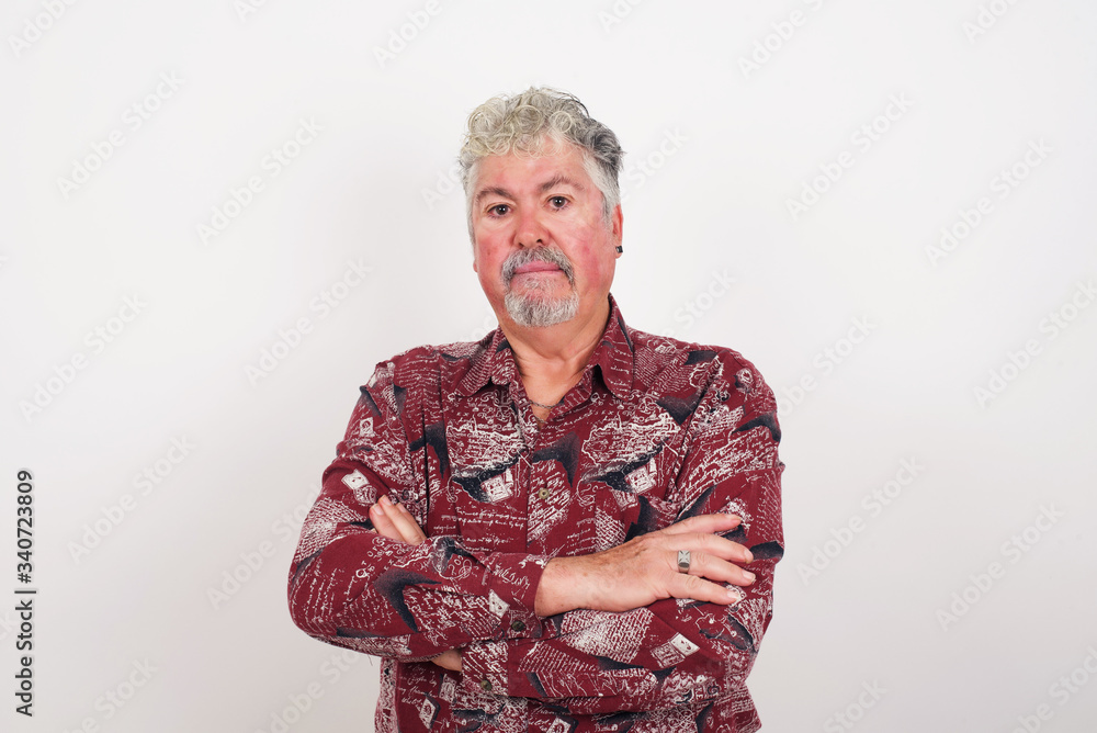 Isolated portrait of stylish young European man bitting his mouth and looking worried and scared crossing arms, worry and doubt. Isolated portrait of stylish young European man bitting his mouth and looking worried and scared crossing arms, worry and doubt.