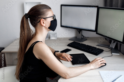 COVID-19 Pandemic Coronavirus Mask Woman Home Working Isolation Laptop Computer Auto Quarantine. Girl wearing face mask smart home working on a home computer against Coronavirus Disease 2019.Complianc