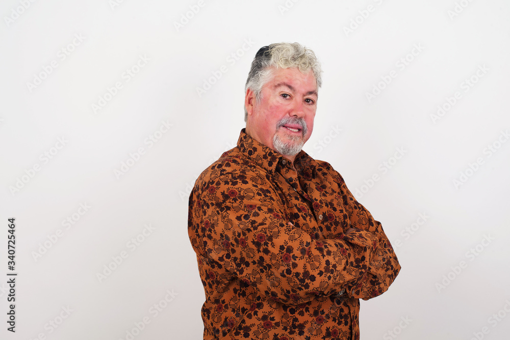 Image of cheerful pretty young caucasian businessman standing indoors with arms crossed. Looking and smiling at the camera. Confident boy. Image of cheerful pretty young caucasian businessman standing indoors with arms crossed. Looking and smiling at the camera. Confident boy.