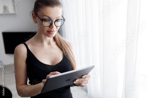 COVID-19 Pandemic Coronavirus Mask Woman Home Working Isolation Laptop Computer Auto Quarantine. Girl wearing face mask smart home working on a home computer against Coronavirus Disease 2019.Complianc