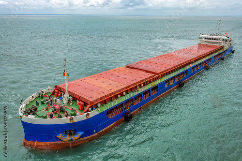 Small multipurpose dry cargo vessel also known locally as barges, used to feed the mother vessels as the bigger vessel sometimes, by itself, could not be anchored at the harbor.