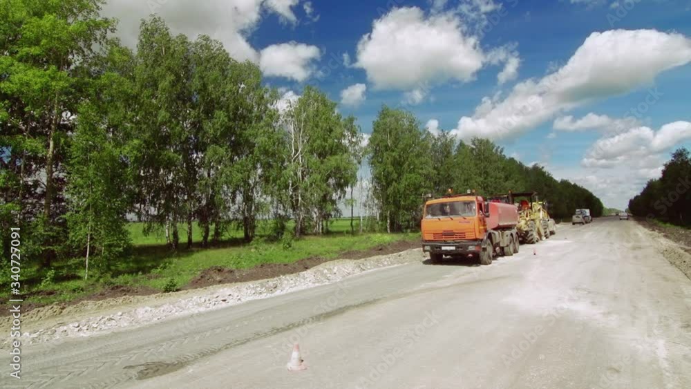 Trucks, excavators and road repair work in rural landscape. Trucks, excavators and road repair work in rural landscape.
