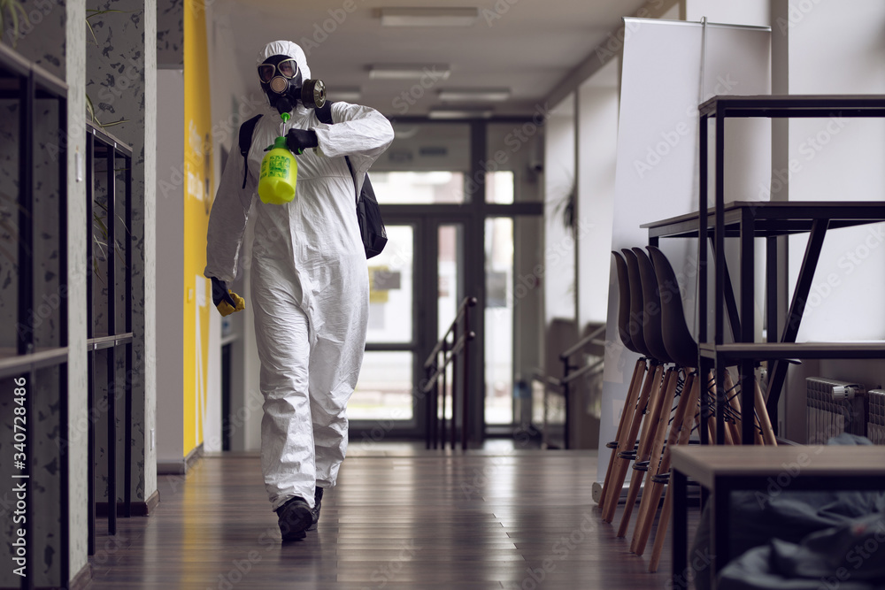 Cleaning and Disinfection at town complex amid the coronavirus epidemic. Professional teams for disinfection efforts. Infection prevention and control of epidemic. Protective suit and mask Cleaning and Disinfection at town complex amid the coronavirus epidemic. Professional teams for disinfection efforts. Infection prevention and control of epidemic. Protective suit and mask