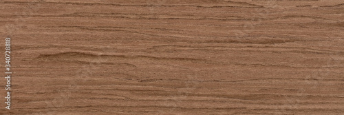 Attractive nut veneer background in grey color. Natural wood texture, pattern of a long veneer sheet, plank.