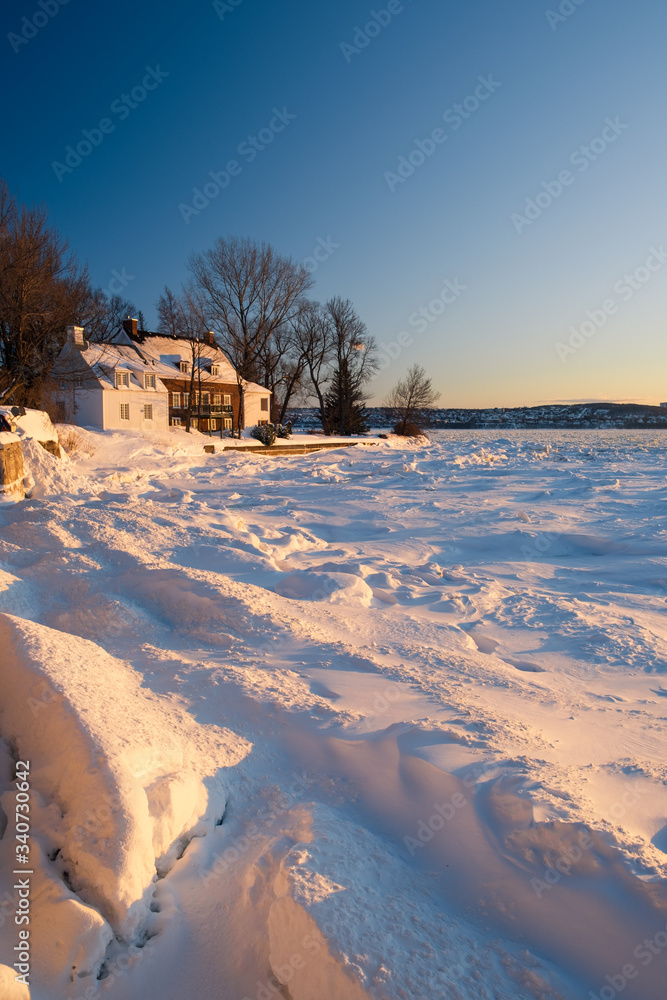 House in snowy landscape in Canada at Sunset