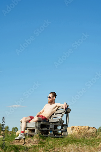 Man Taking Sunbath On Summer Day