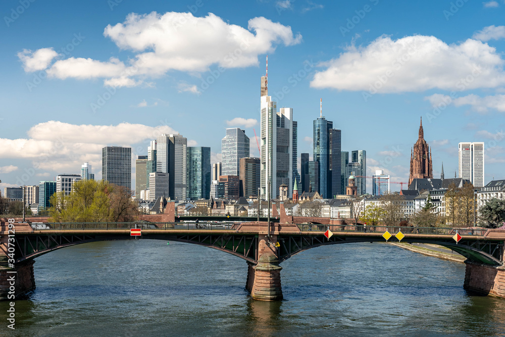 Naklejka premium Frankfurt, Germany - March 31, 2020: frankfurt skyline view with ignas bubis bridge during daytime