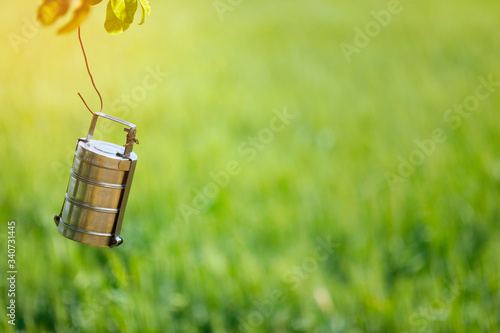 Tiffin hanging on tree , indian farmer