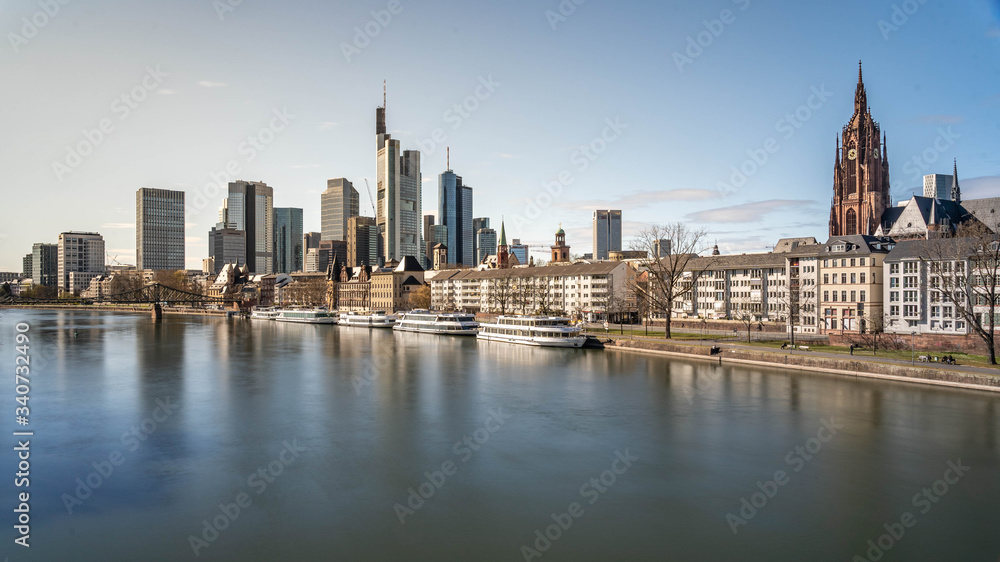 Frankfurt, Germany - March 31, 2020: view on frankfurt skyline and dom from main riverside during springtime