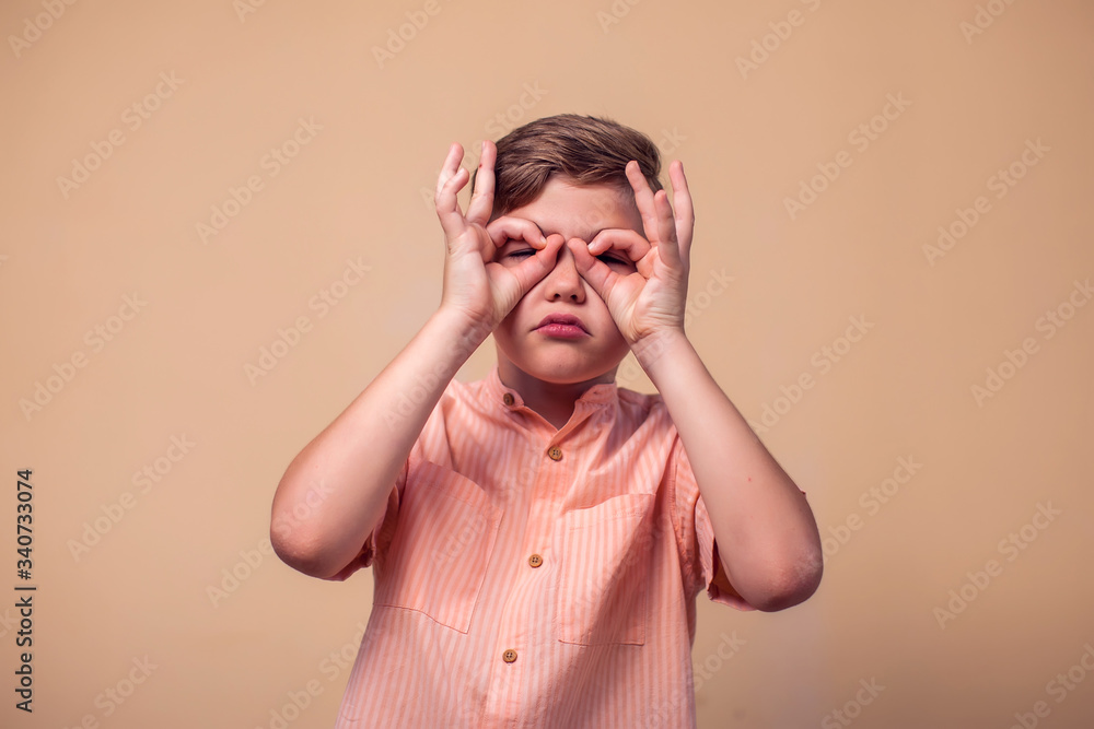 A portrait of kid boy showing okay gesture. Children and emotions concept A portrait of kid boy showing okay gesture. Children and emotions concept