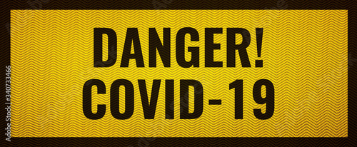 Text danger covid-19 on yellow background with black frame