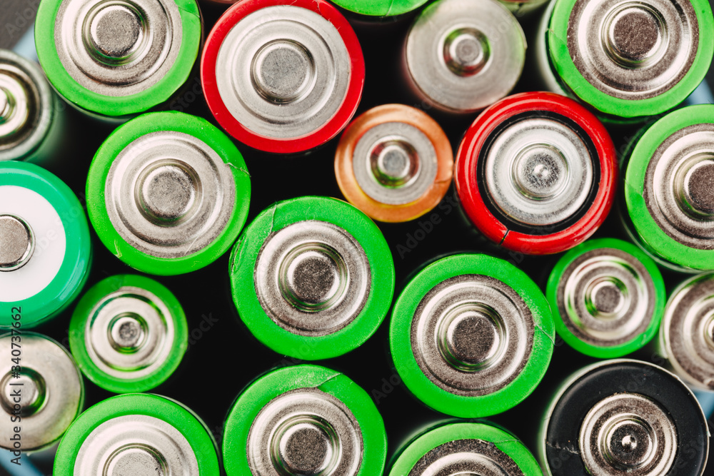 Closeup of group of used disposable batteries of various color. Closeup of group of used disposable batteries of various color.