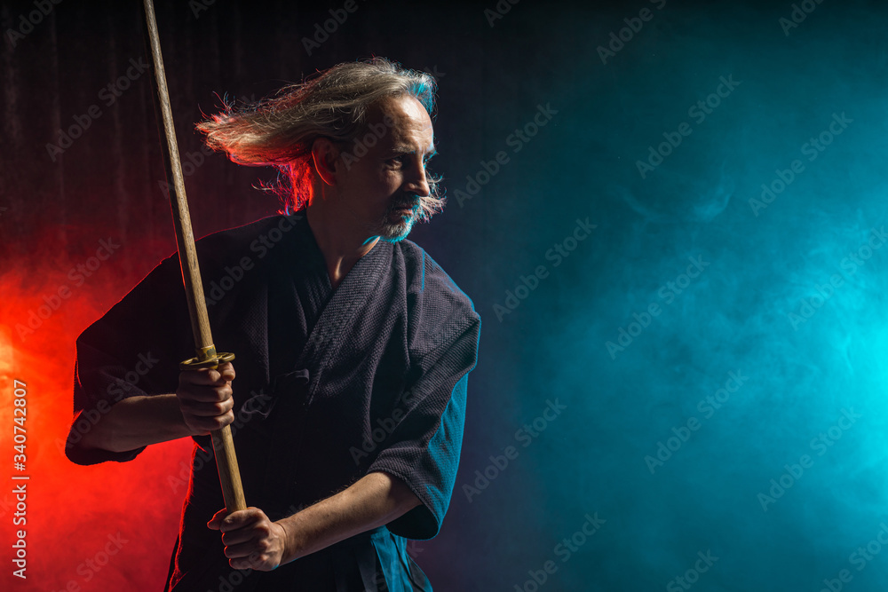 confident caucasian kendo warrior in traditional outfit use bamboo sword shinai for fighting, katana, samurai concept