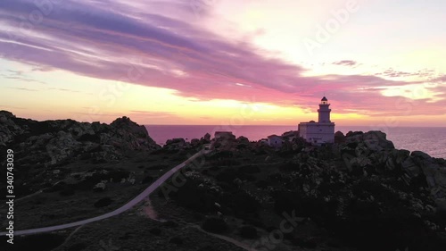  moving lighthouse panorama during sunset with huge granite cliffs and red sea photo