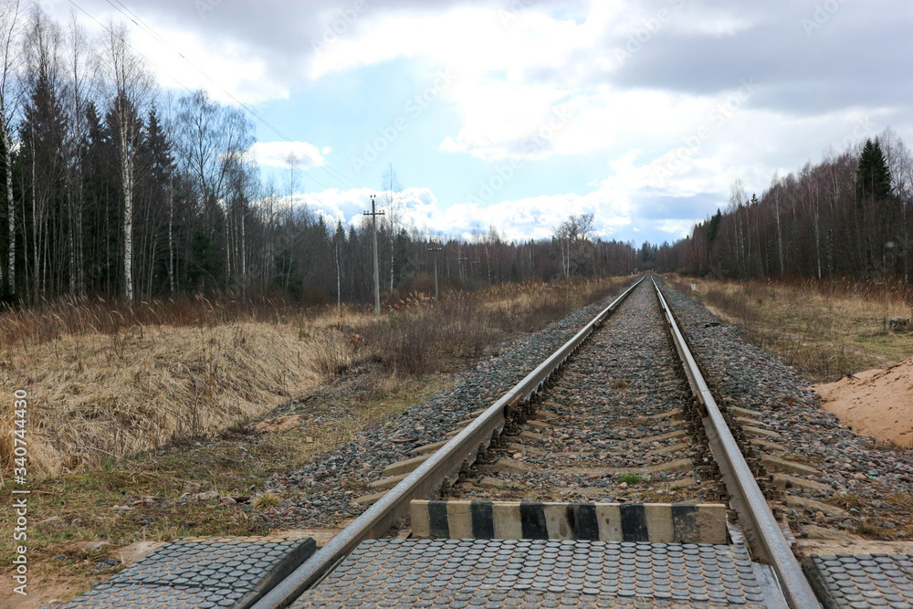 Spring view of single track railway in the distance Spring view of single track railway in the distance