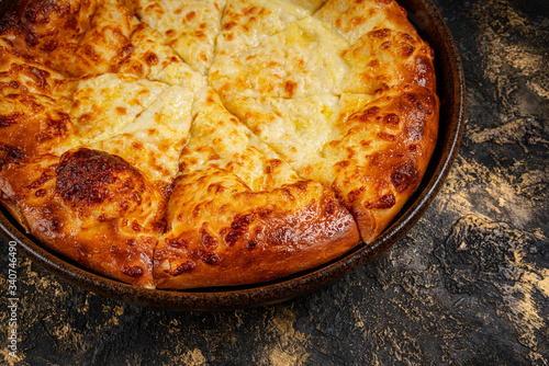 khachapuri with cheese on black background