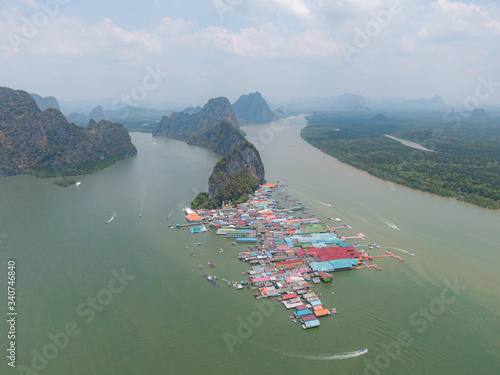 Drone shot of Aerial view over Ko Panyi floating village in south of Thailand. Ko Panyi is a fishing and muslim village in Phang Nga Province. With small islands as background.