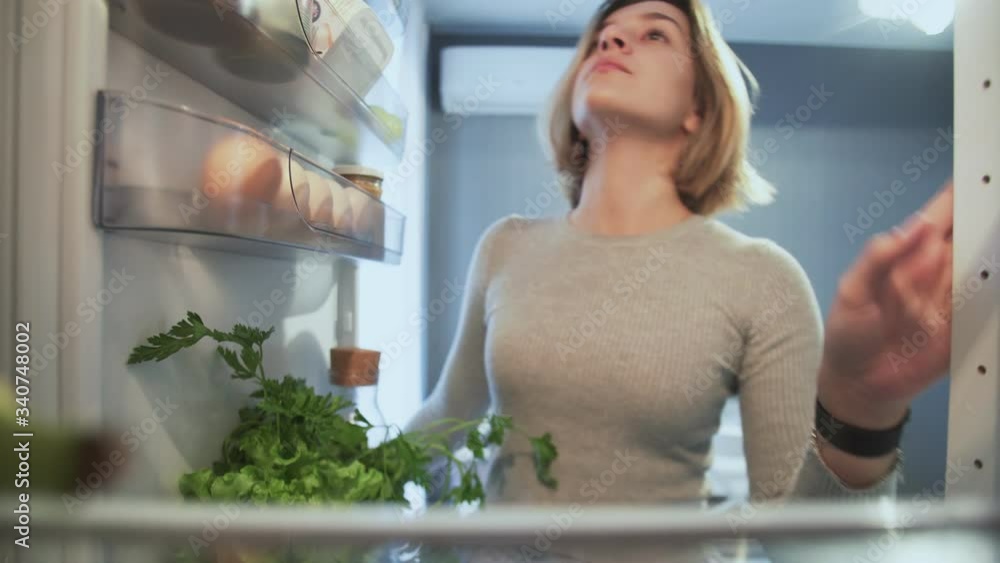 View Looking Out From Inside Of Refrigerator As Woman opens door View Looking Out From Inside Of Refrigerator As Woman opens door