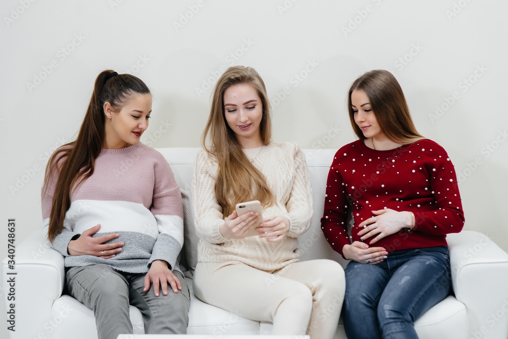 Pregnant girls are waiting for the doctor in the waiting room Pregnant girls are waiting for the doctor in the waiting room