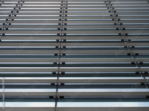 a vertical perspective view of the facade of a modern glass commercial building with steel frames