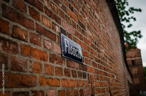 STREET NAME PLAQUE ON A BRICK WALL IN THE CITY CENTER
