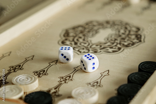 Backgammon table game, game chips and dice closeup. Enjoying life, slow living, stop rushing.