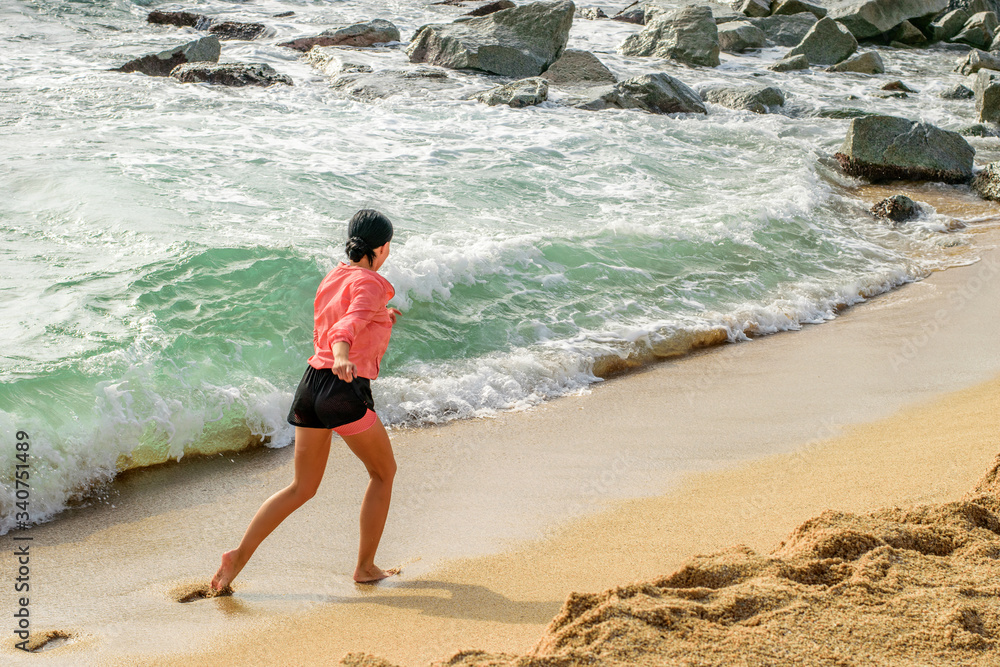 Sports girl running on the beach. Sport outdoor activities, enjoying life.
