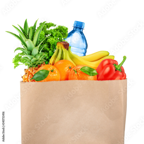 Grocery bag with fruits and vegetables isolated on white