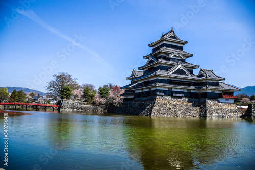 Iconic traditional japanese castle in the middle of turquoise lake in Matsumoto  Japan