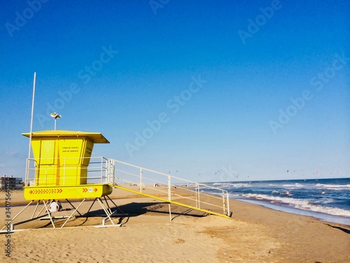 Sunny day on the beach with windsurfers © Ekaterina