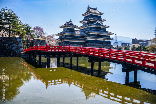 Japanese castle and red bridge in Matsumoto, Japan